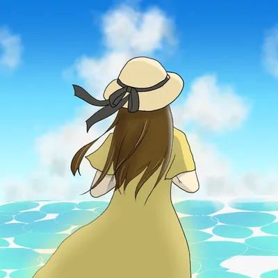 夏の海辺に立つ麦わら帽子の女性の後ろ姿